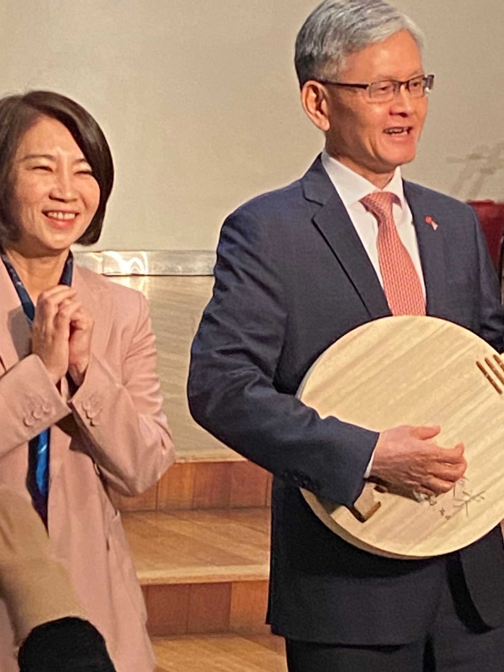 Ambassador James K.J. Lee of the Taipei Economic and Cultural Office in New York tries out the moon guitar, next to the magistrate of Pingtung County, Chou Chun-mir at the "Tunes from the Islands: An AAPI Celebration Event," on April 30, 2024.