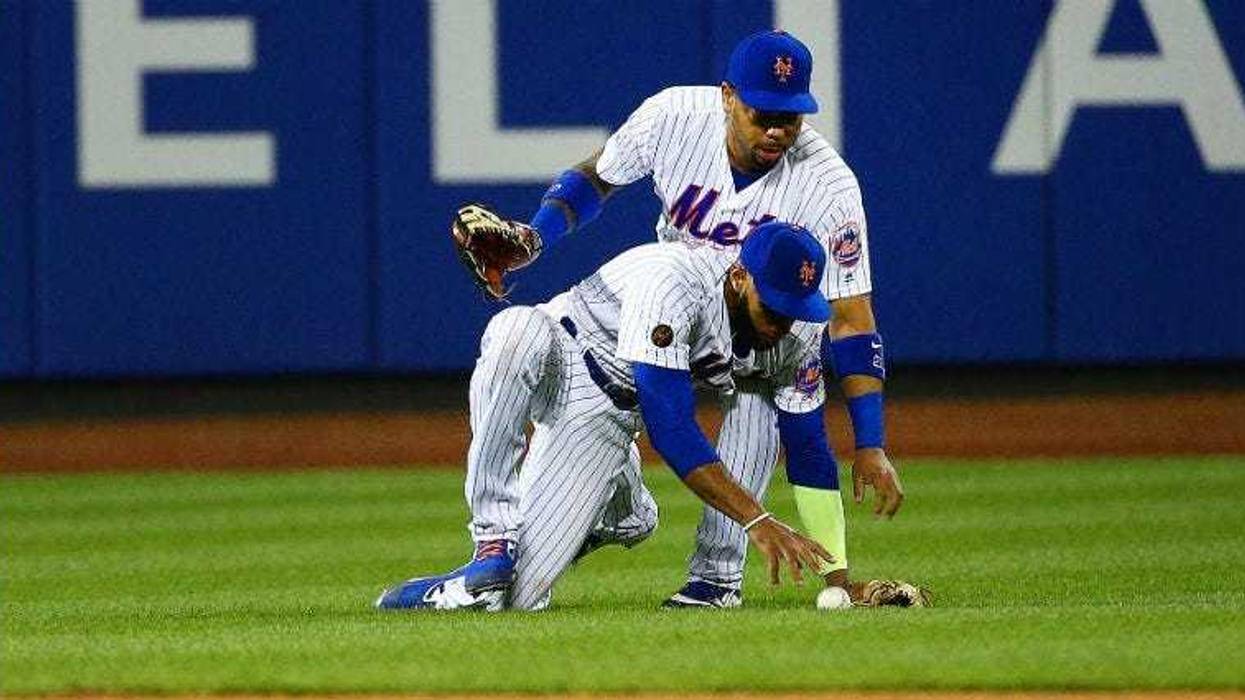 Amed Rosario and Dominic Smith collide and drop a fly ball for a run against the San Francisco Giants during the 13th inning at Citi Field