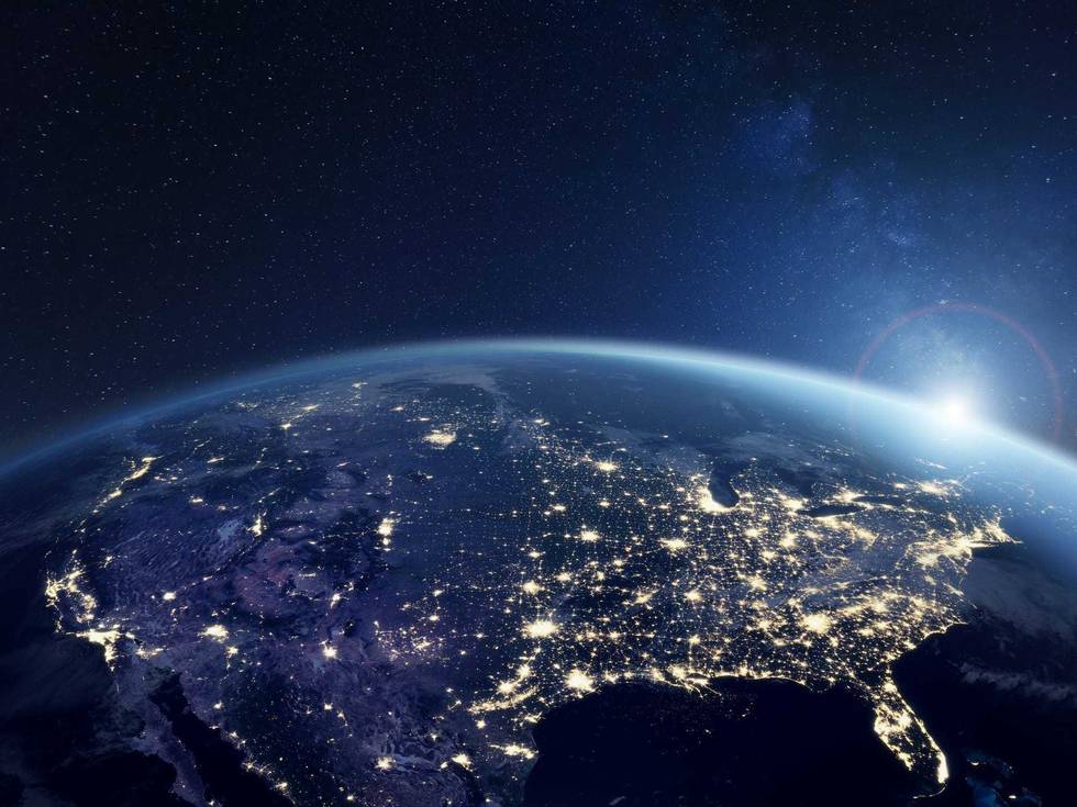 America at night viewed from space with city lights showing activity in United States.