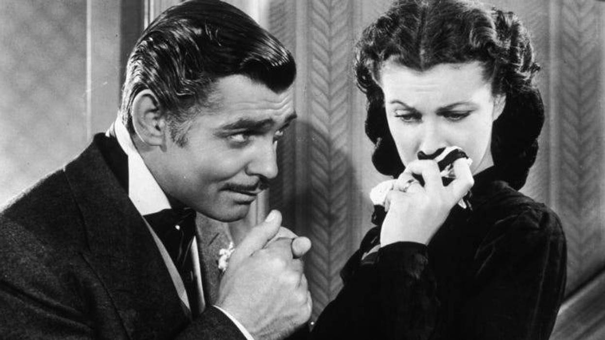 American actor Clark Gable in his role as Rhett Butler kissing the hand of a tearful Scarlett O'Hara, played by Vivien Leigh, in "Gone With The Wind."