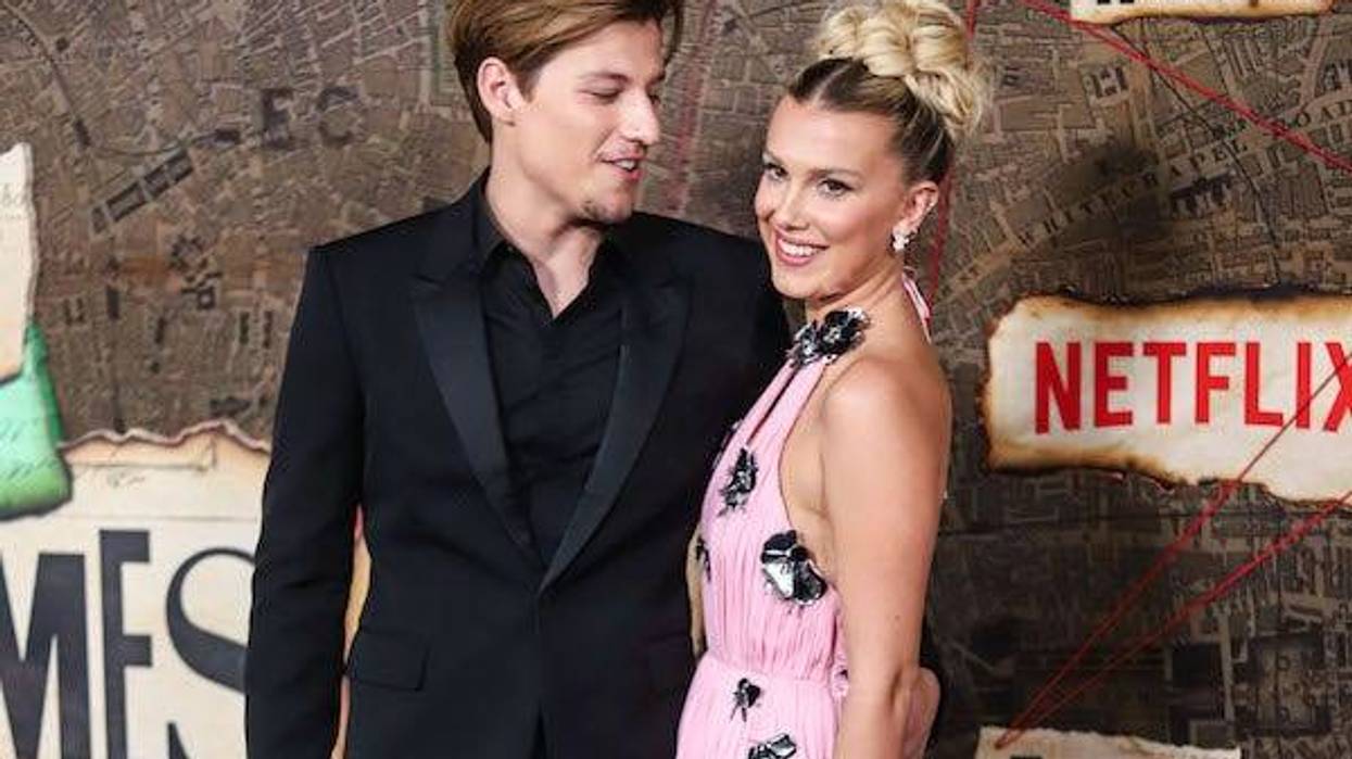 American actor Jake Bongiovi and girlfriend/British actress Millie Bobby Brown wearing Louis Vuitton arrive at the World Premiere Of Netflix's 'Enola Holmes 2' held at The Paris Theater on October 27, 2022 in Manhattan, New York City, New York