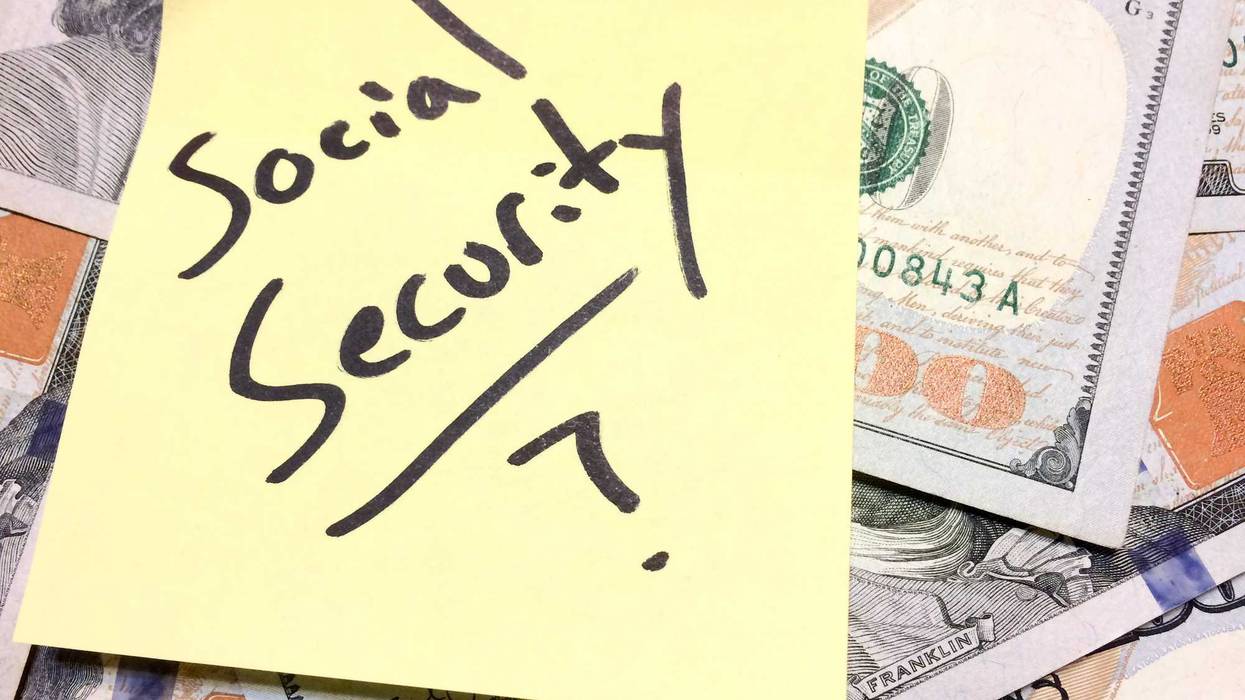 American cash money and yellow paper note Social Security with question mark in black color aerial view