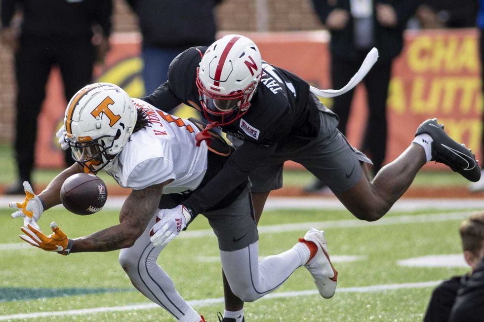 American defensive back Cam Taylor-Britt of Nebraska (25) knocks the ball away from American wide receiver Velus Jones Jr. of Tennessee (1) during American practice for the 2022 Senior Bowl at Hancock Whitney Stadium.