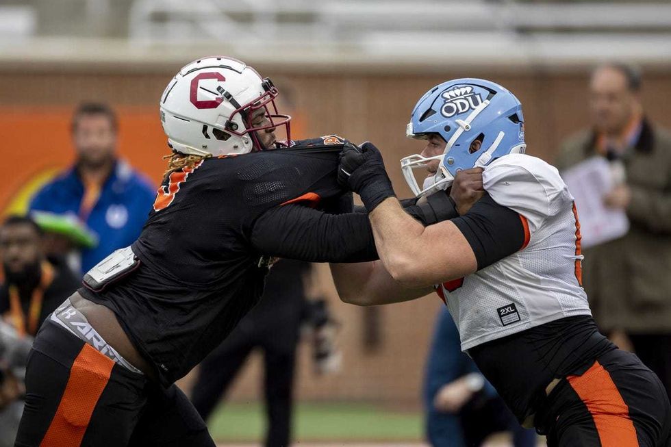 American defensive lineman Zacch Pickens of South Carolina (3) spars with American offensive lineman Nick Saldiveri of Old Dominion (59) practices during the third day of Senior Bowl week at Hancock Whitney Stadium in Mobile.