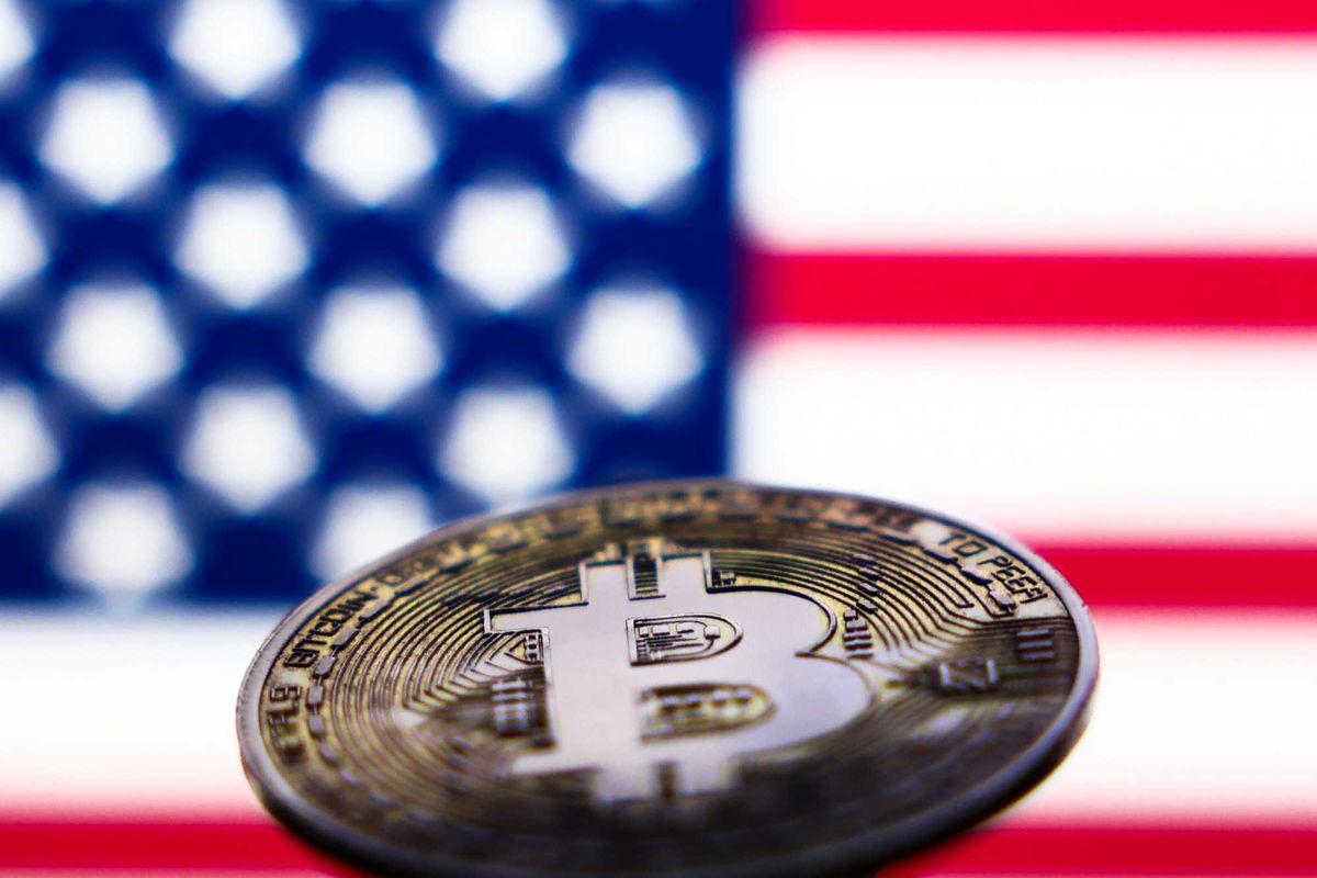 American flag displayed on a laptop screen and representation of Bitcoin cryptocurrency are seen in this illustration photo taken in Krakow, Poland on November 6, 2024.