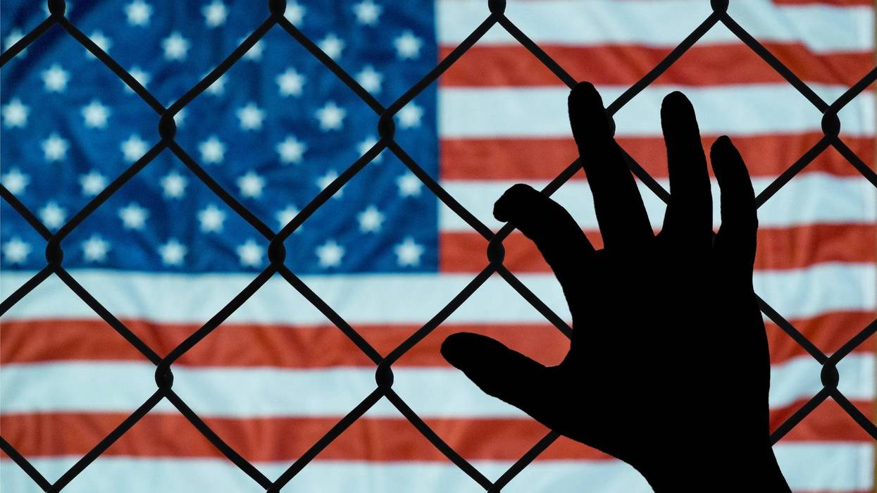 American flag seen through a fence