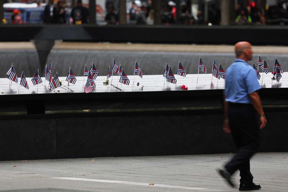 American flags are seen on the names of victims of the 9/11 terror attack during the annual 9/11 Commemoration Ceremony at the National 9/11 Memorial and Museum on September 11, 2022 in New York City.