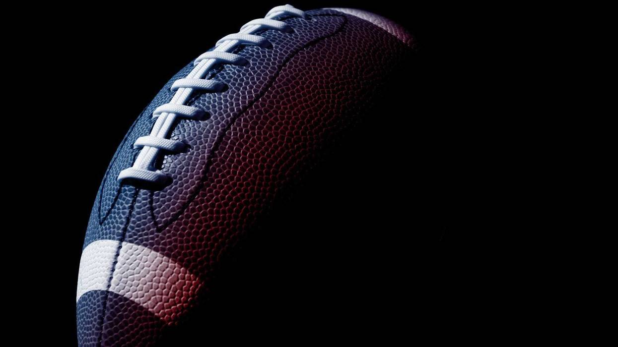 American football ball close up on black background