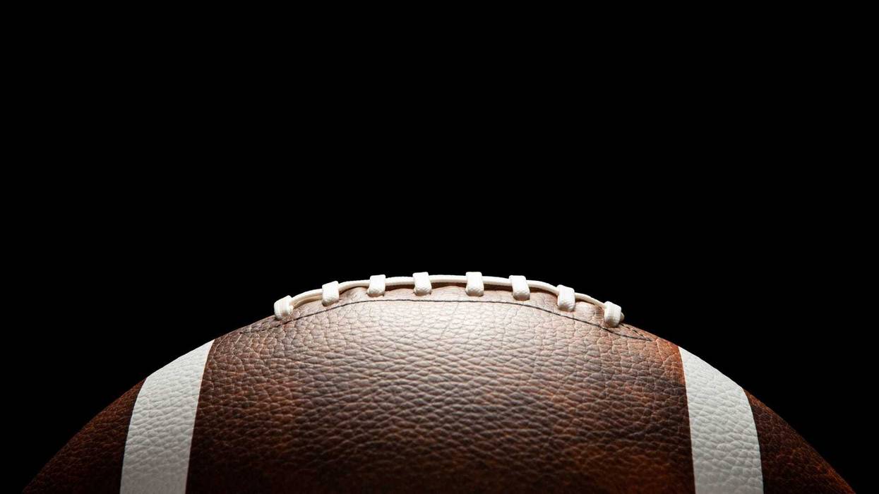 American football ball on dark background