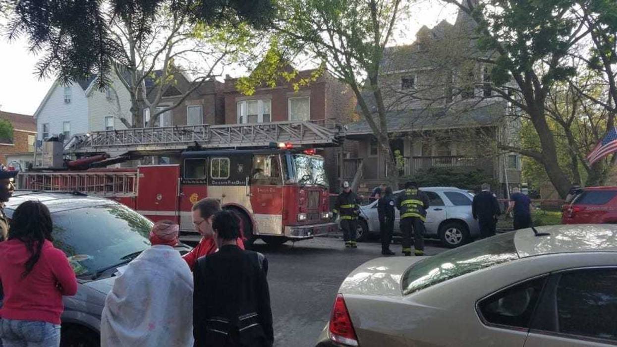 American Red Cross volunteers assist residents displaced by a house fire May 15 in the 6900 block of South King Drive.