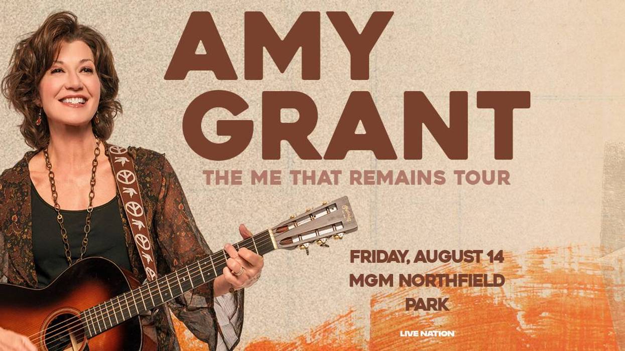 Amy Grant smiling, playing guitar for "The Me That Remains Tour" on Aug 14 at MGM Northfield.