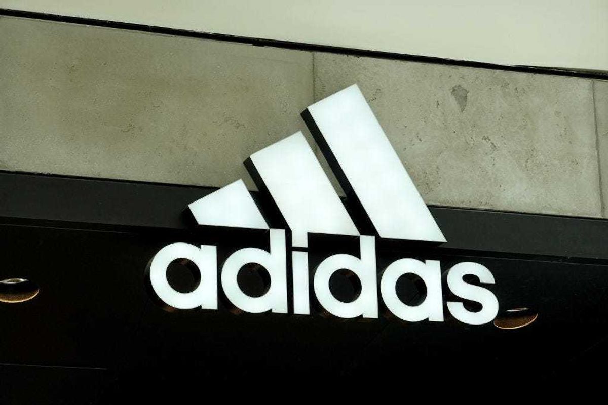 An Adidas sign at the entrance to the store on August 12, 2021 in Miami, Florida. Adidas is reported to have reached an agreement to sell its Reebok brand to Authentic Brands for nearly $2.5 billion.