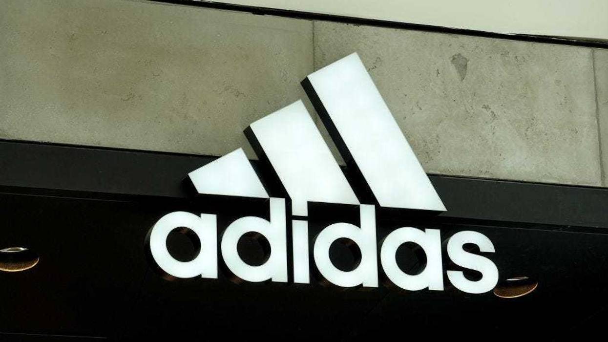 An Adidas sign at the entrance to the store on August 12, 2021 in Miami, Florida. Adidas is reported to have reached an agreement to sell its Reebok brand to Authentic Brands for nearly $2.5 billion.