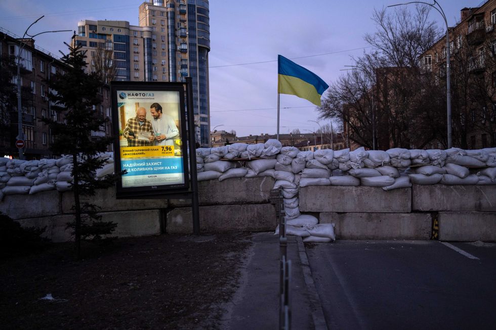 An advertising billboard in front of a barricade in Kyiv, Ukraine, Monday, March 21, 2022