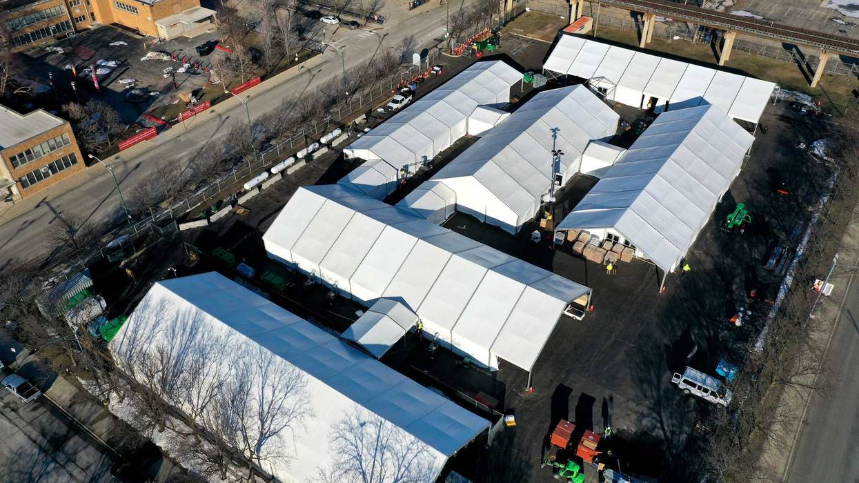 An aerial photo shot with a drone shows a COVID-19 vaccination center in a parking lot of the United Center, home to the NBA Bulls and NHL Blackhawks, on March 02, 2021 in Chicago, Illinois. The site is projected to distribute 6,000 vaccines-per-day once it begins operation next week
