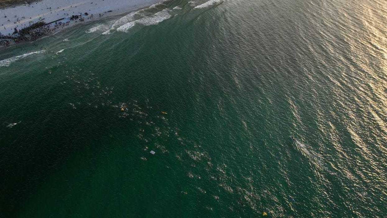 An aerial view of age group athletes competing in the swim course at IRONMAN Florida on November 05, 2022 in Panama City Beach, Florida. (Photo by Patrick McDermott/Getty Images for IRONMAN)