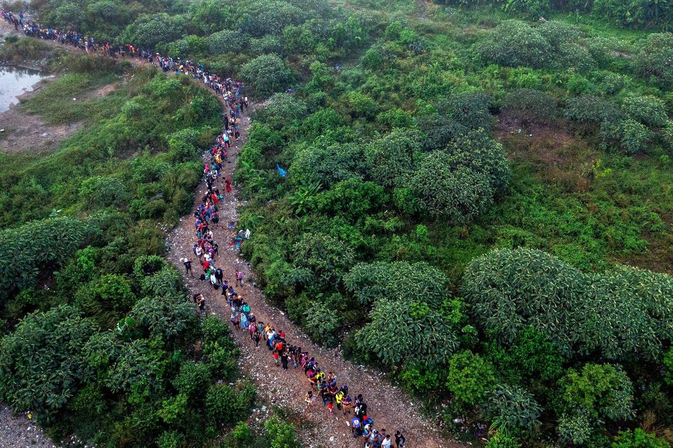An aerial view of migrants walking by the jungle near Bajo Chiquito village, the first border control of the Darien Province in Panama, on Sept. 22, 2023