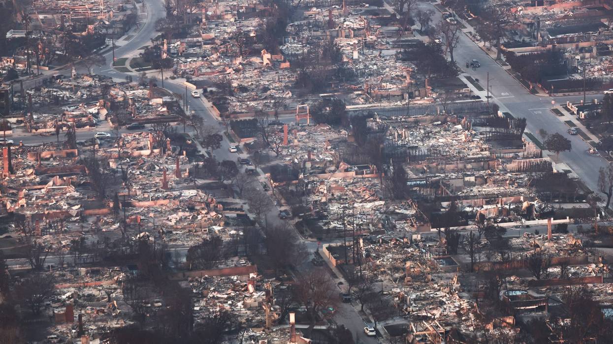 An aerial view shows destroyed homes as the Palisades Fire continues to burn on January 09, 2025 in Pacific Palisades, California.