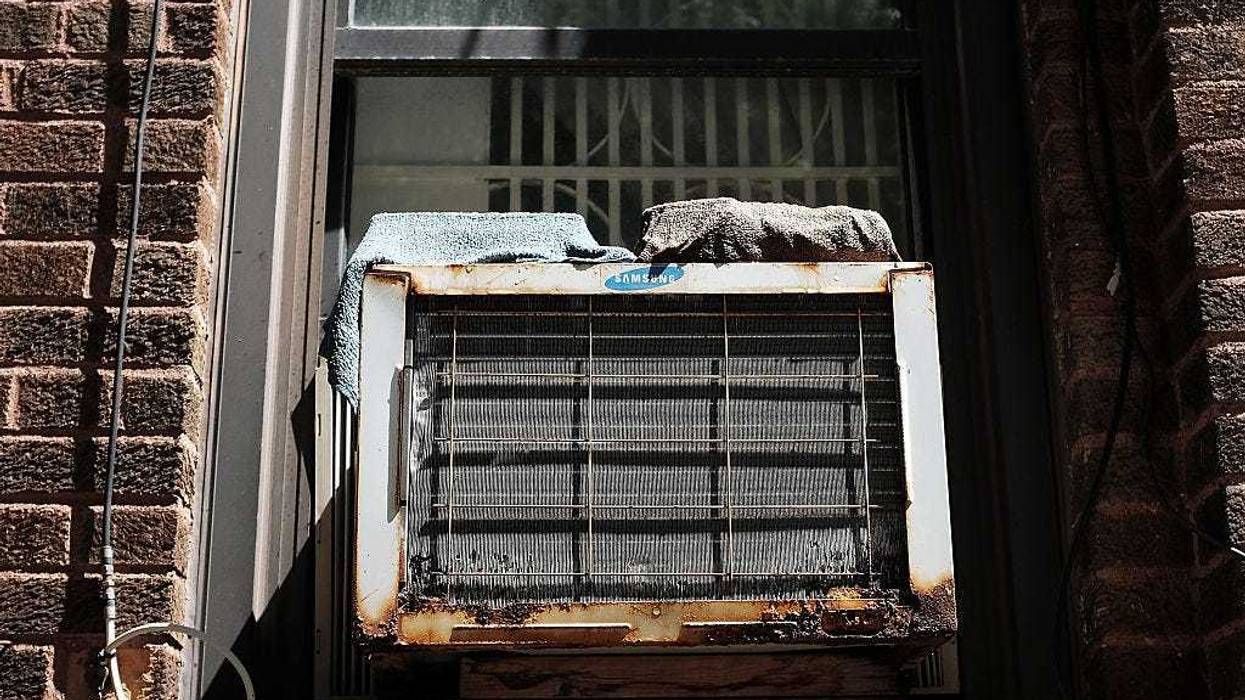 An air conditioner is viewed in a window at Brighton Beach in Brooklyn on August 20, 2015 in New York City.
