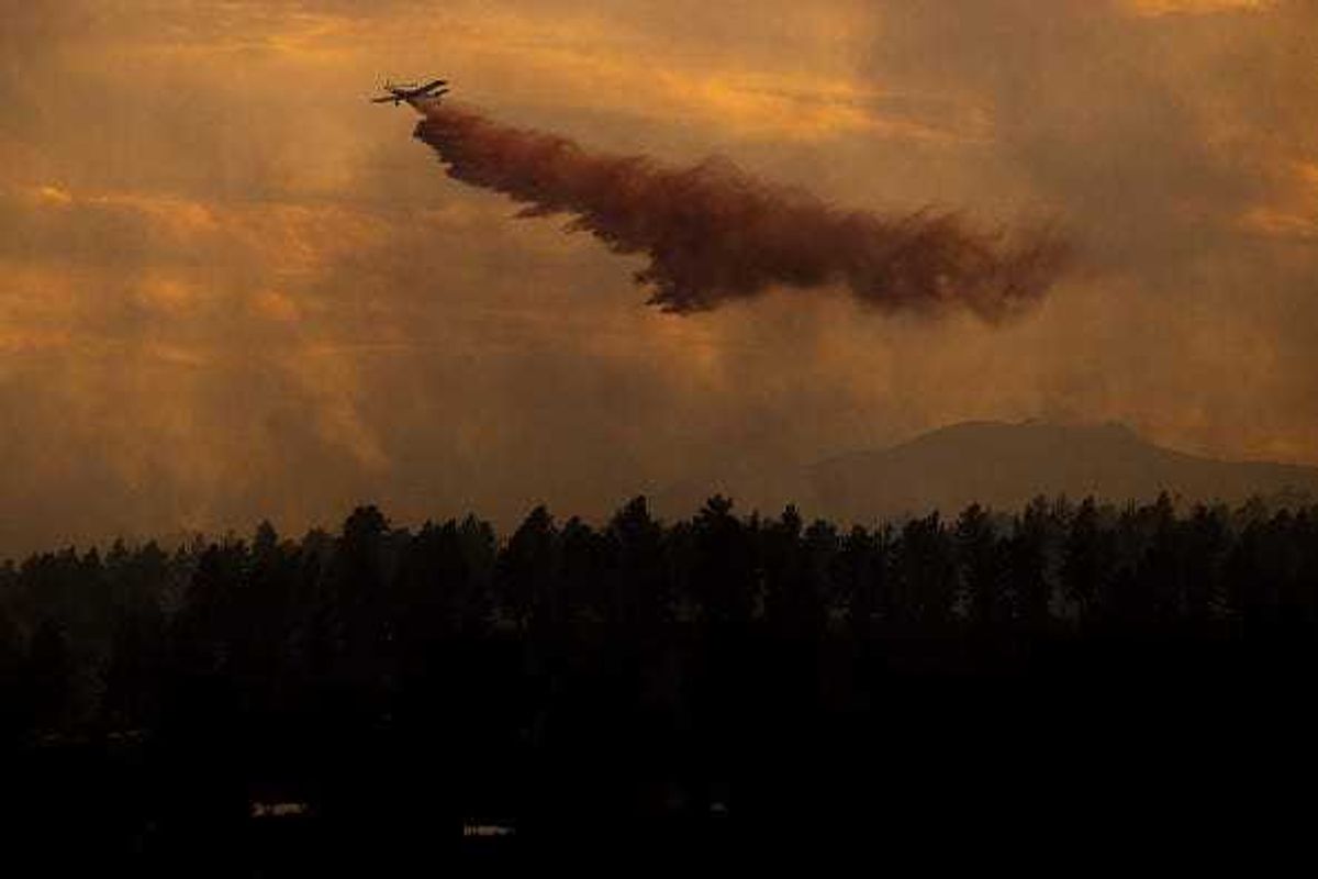 An air tanker drops slurry on the NCAR Fire on March 26, 2022 in Boulder, Colorado. The wildfire, which has forced almost 20,000 people to evacuate their homes, started just a few miles away from where the Marshall Fire destroyed more than 1,000 homes in December.
