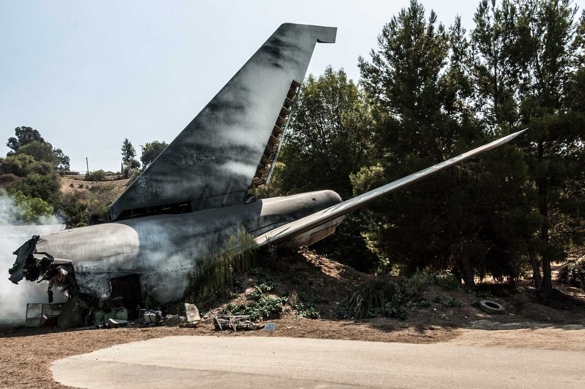An airplane tail at a plane crash site.