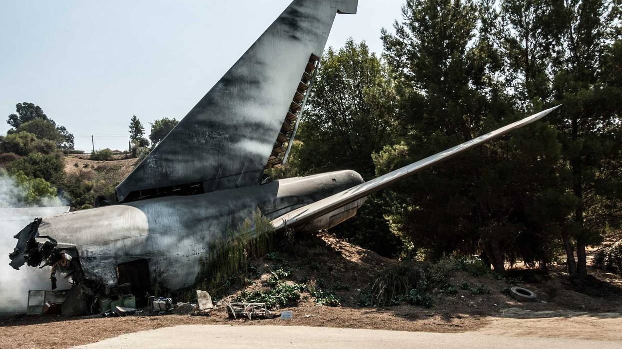 An airplane tail at a plane crash site.