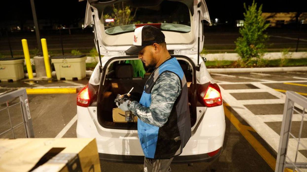 An Amazon driver works at a fulfillment center.