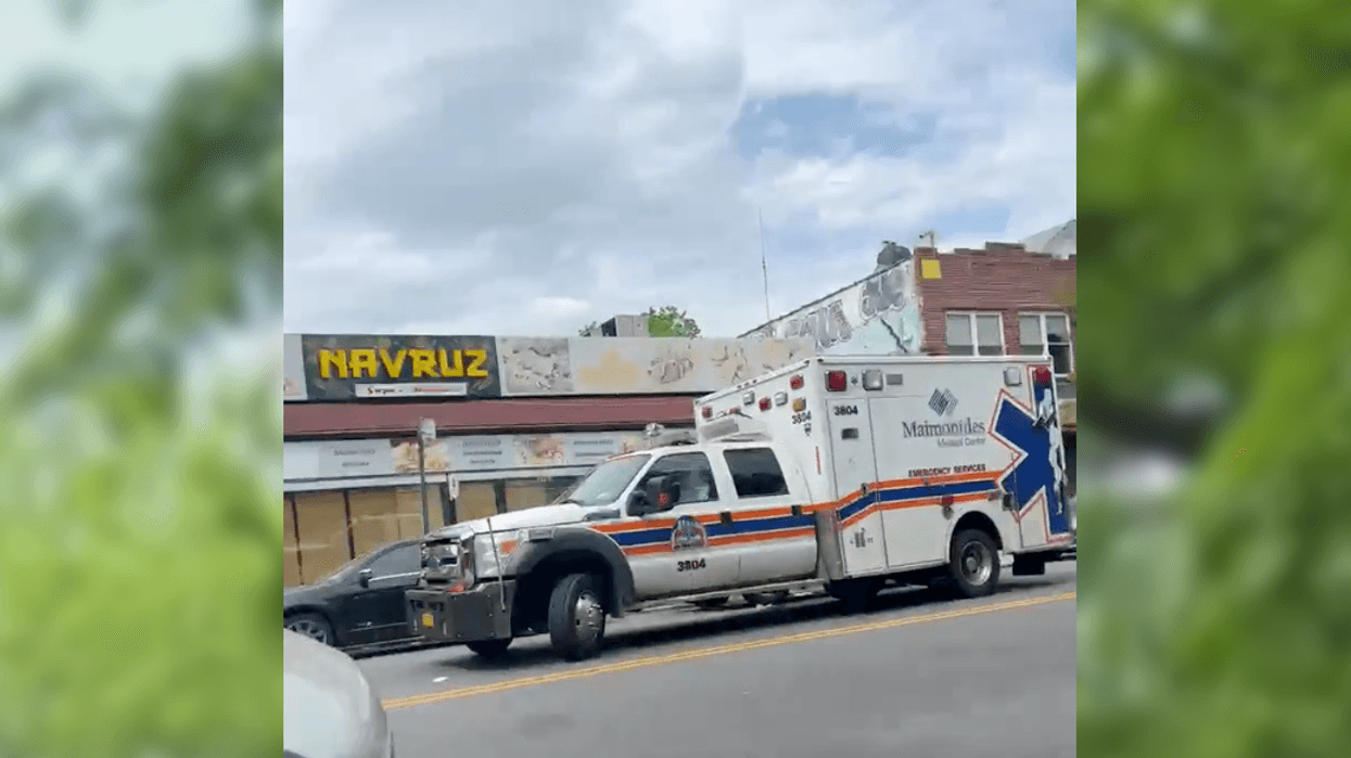 An ambulance outside Navruz Market at 1701 McDonald Ave. in Midwood on Monday afternoon