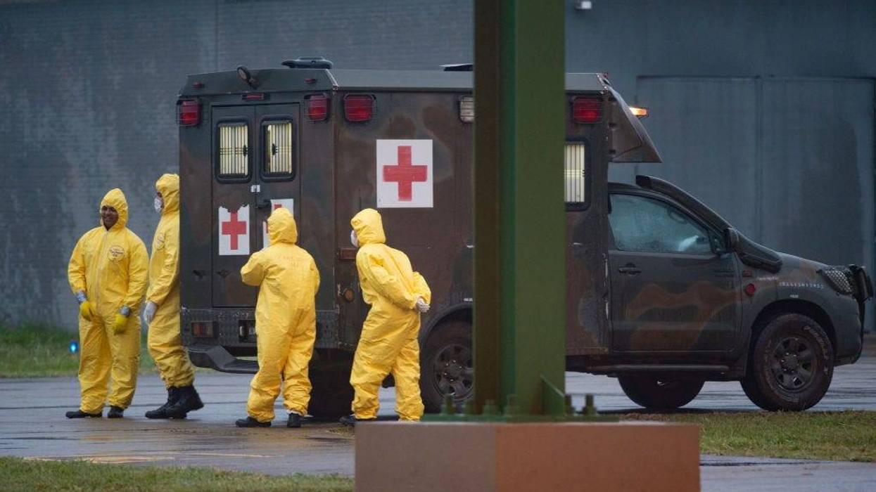 An ambulance waits for Brazilian citizens coming from the Chinese city of Wuhan, at the Air Force base of Anapolis, State of Goias, on February 9, 2020, Goias, Brazil. The rescued will stay in a kind of hotel inside the Air Base for 18 days. Those who show any symptoms of coronavirus go to another building still on the air base, and if necessary they will be transferred to the armed forces hospital in Brasilia.