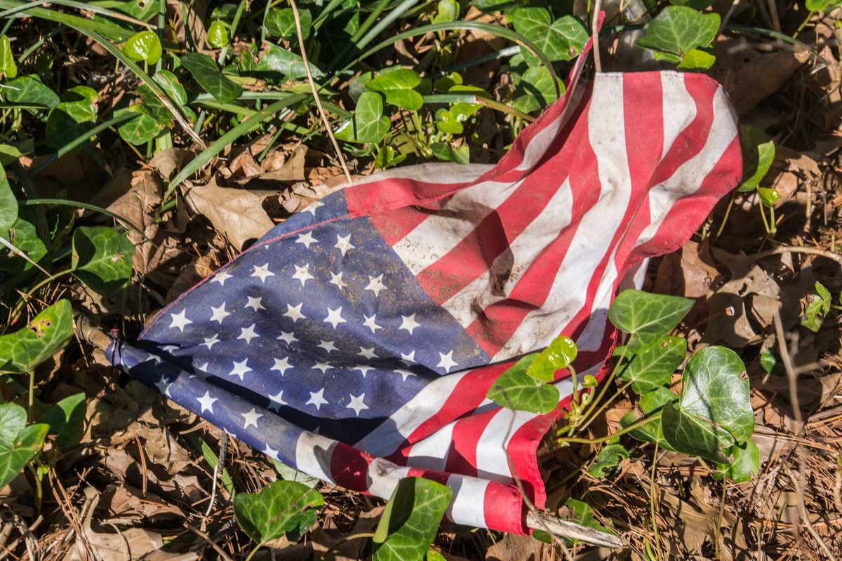 An American Flag can be seen on the ground.