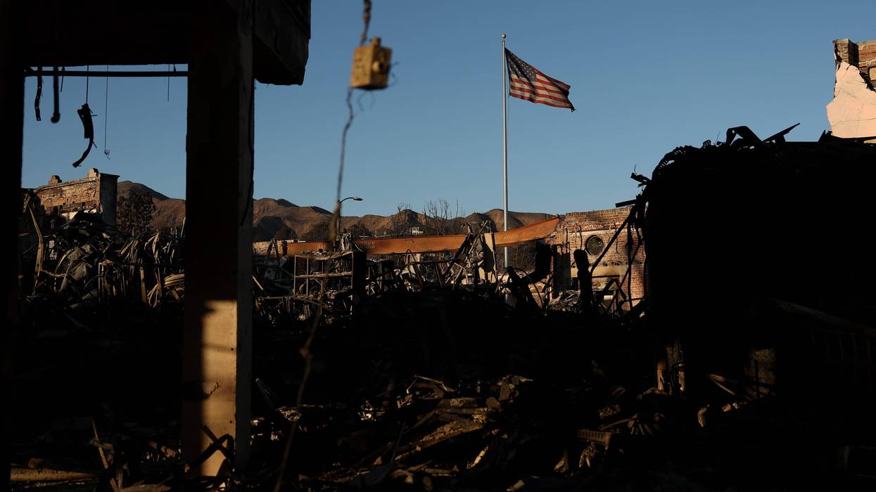 An American flag flies near a commercial building destroyed in the Palisades Fire on January 12, 2025 in Pacific Palisades, California.