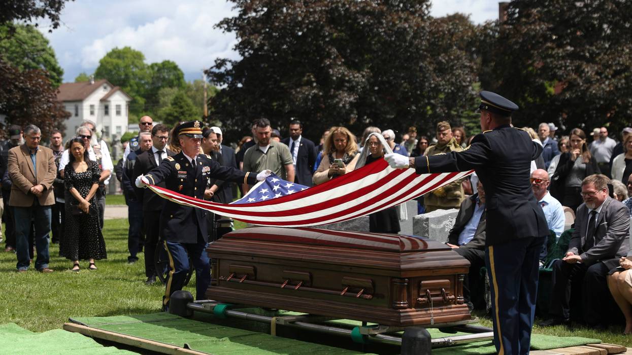 An American flag is folded during the interment for World War II U.S. Army Air Forces Staff Sgt. Eugene Darrigan at the cemetery behind St. Mary's church, Saturday, May 24, 2025, in Wappingers Falls, N.Y. Darrigan was buried in his hometown after his remains were recovered from a World War II bomber that crashed into the water off the coast of New Guinea on March 11, 1944.