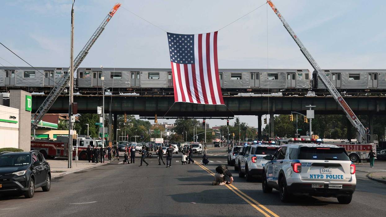 An American flag is raised as people arrive for the funeral of slain NYPD officer Didarul Islam at Parkchester Jame Masjid on July 31, 2025