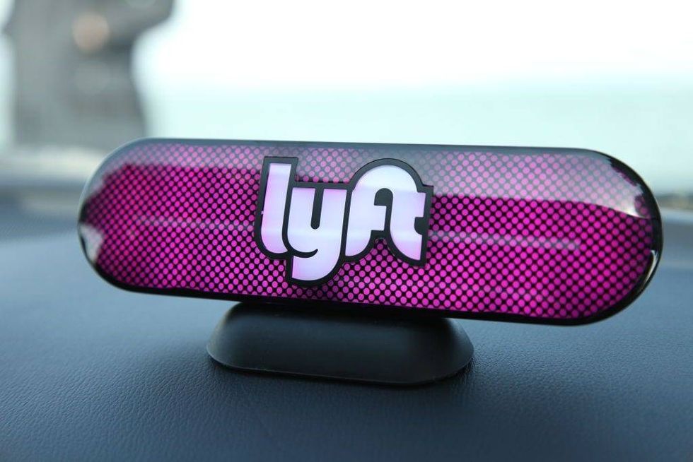 An Amp sits on the dashboard of a Lyft driver