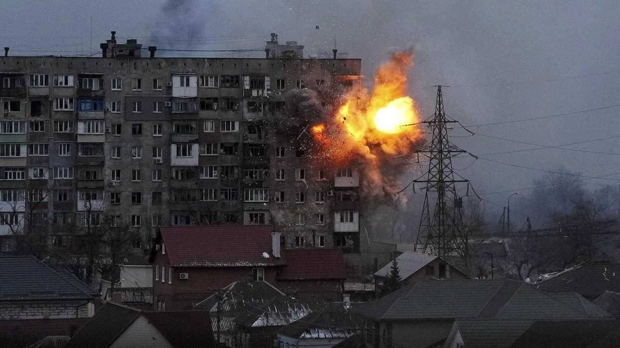 An apartment building explodes after a Russian army tank fires in Mariupol, Ukraine, March 11, 2022.