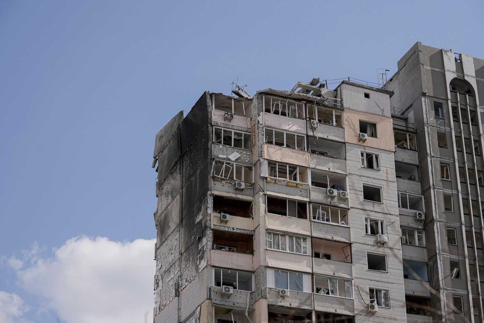 An apartment building is damaged after parts of a Russian missile, shot down by Ukrainian air defense, landed in a residential area, according to authorities, in Kyiv, Ukraine, Thursday, March 17, 2022