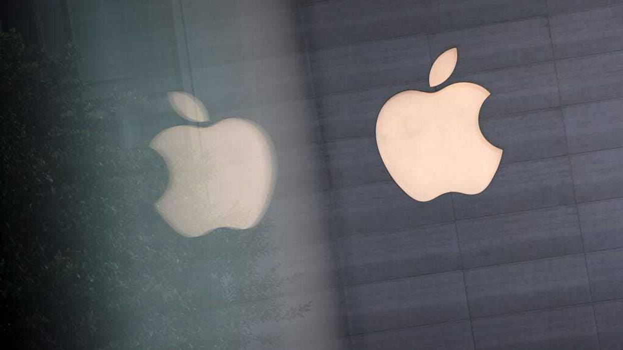 An Apple logo is reflected on glass at the Apple Store at Orchard Road on September 24, 2021 in Singapore.