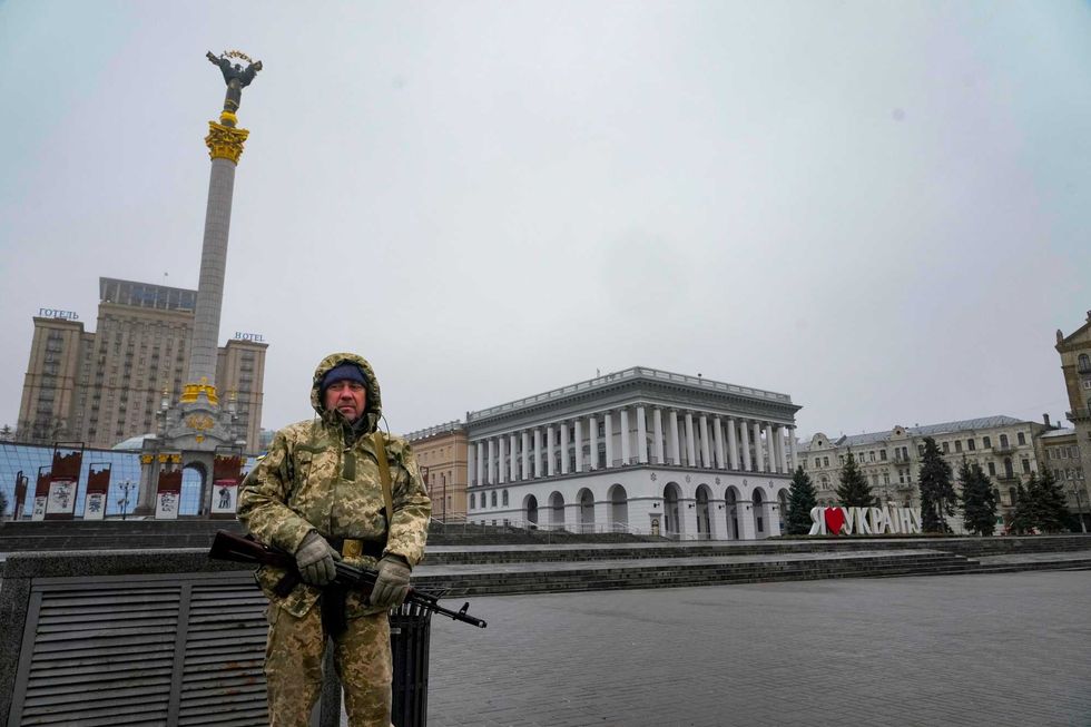 An armed man stands at the Independent Square (Maidan) in the center of Kyiv, Ukraine, Wednesday, March 2, 2022