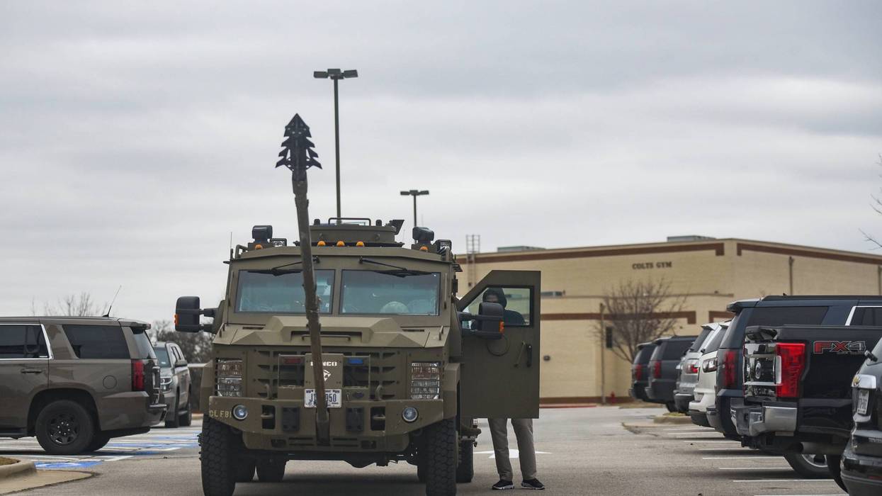 An armored truck is parked in the parking lot of Colleyville Middle School Texas. Police responded to a hostage situation at Beth Israel Congregation synagogue after reports of a man with a gun was holding hostages.