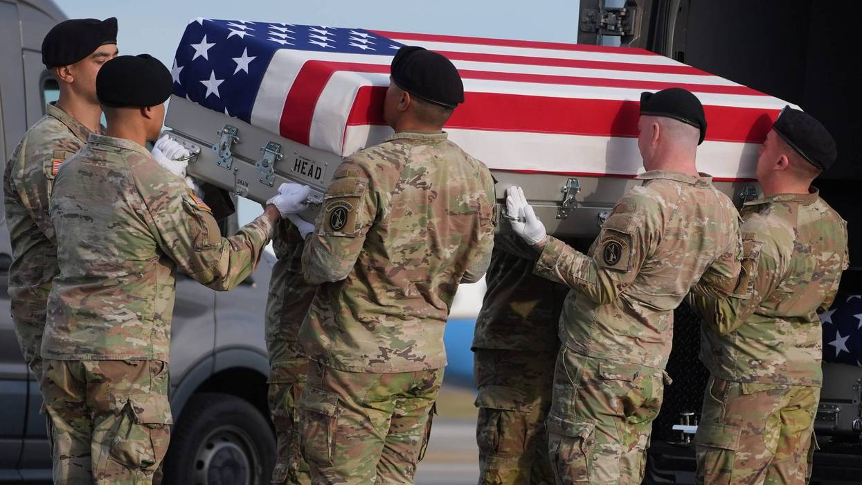 An Army carry team places the flag-draped transfer case with the remains of civilian interpreter Ayad Mansoor Sakat of Macomb, Mich., into the transfer vehicle during a casualty return, Wednesday, Dec. 17, 2025, at Dover Air Force Base, Del.
