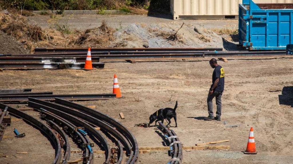 An ATF officer patrols the VTA light rail yard on Wednesday.