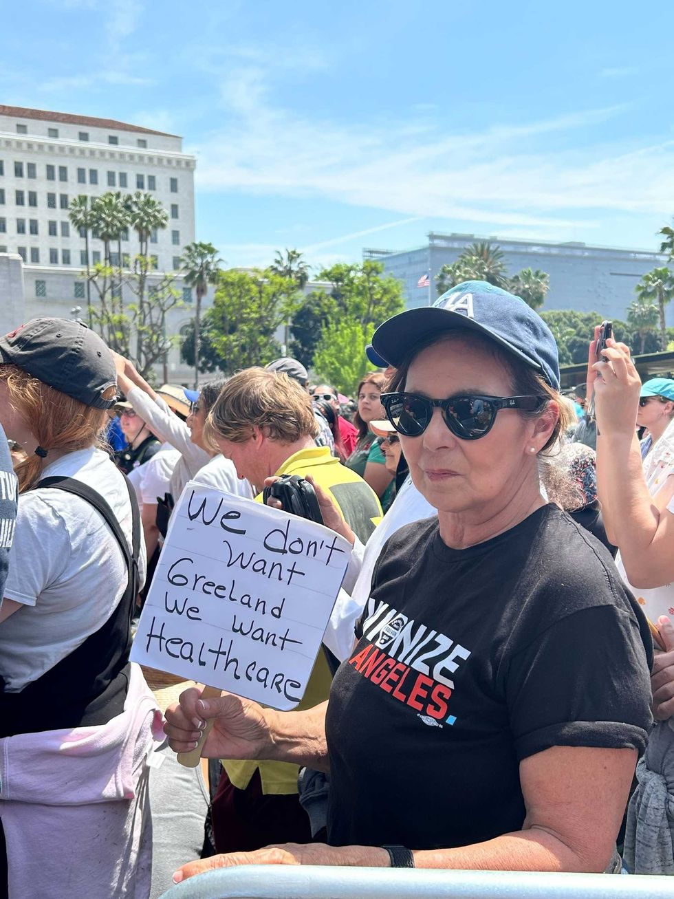 An attendee with a sign at the April 12, 2025 rally in Los Angeles.