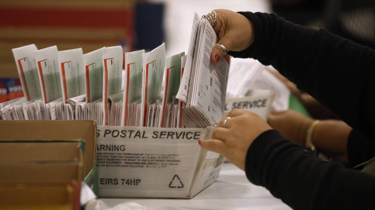 An election worker processes mail-in ballots in California during the state's 2026 primary election.