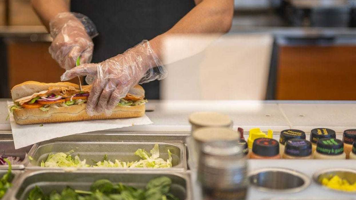 An employee halves a Subway sandwich at a Subway restaurant on January 12, 2023 in Austin, Texas.