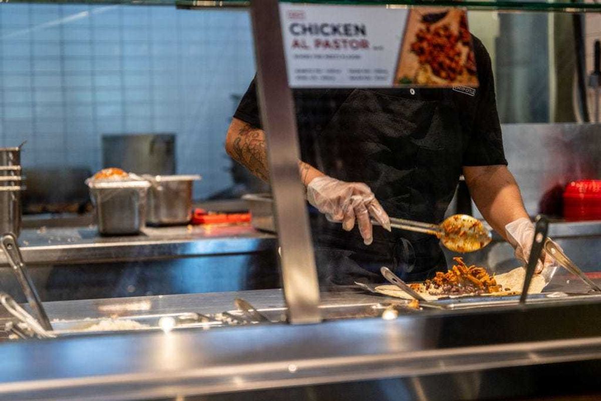 An employee prepares food at a Chipotle Mexican Grill restaurant on April 26, 2023 in Austin, Texas. Chipotle Mexican Grill posted strong quarterly earnings. Chipotle shares climbed as same-store sales rose 10.9%. (Photo by Brandon Bell/Getty Images)