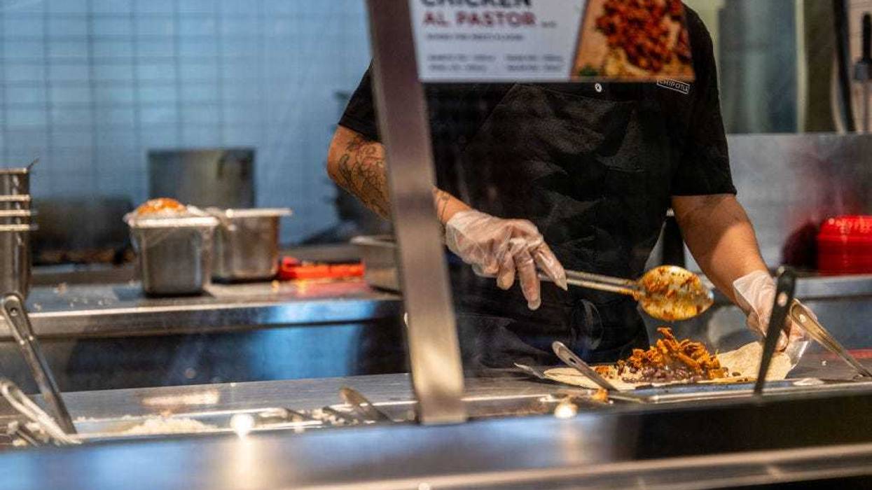 An employee prepares food at a Chipotle Mexican Grill restaurant on April 26, 2023 in Austin, Texas. Chipotle Mexican Grill posted strong quarterly earnings. Chipotle shares climbed as same-store sales rose 10.9%. (Photo by Brandon Bell/Getty Images)