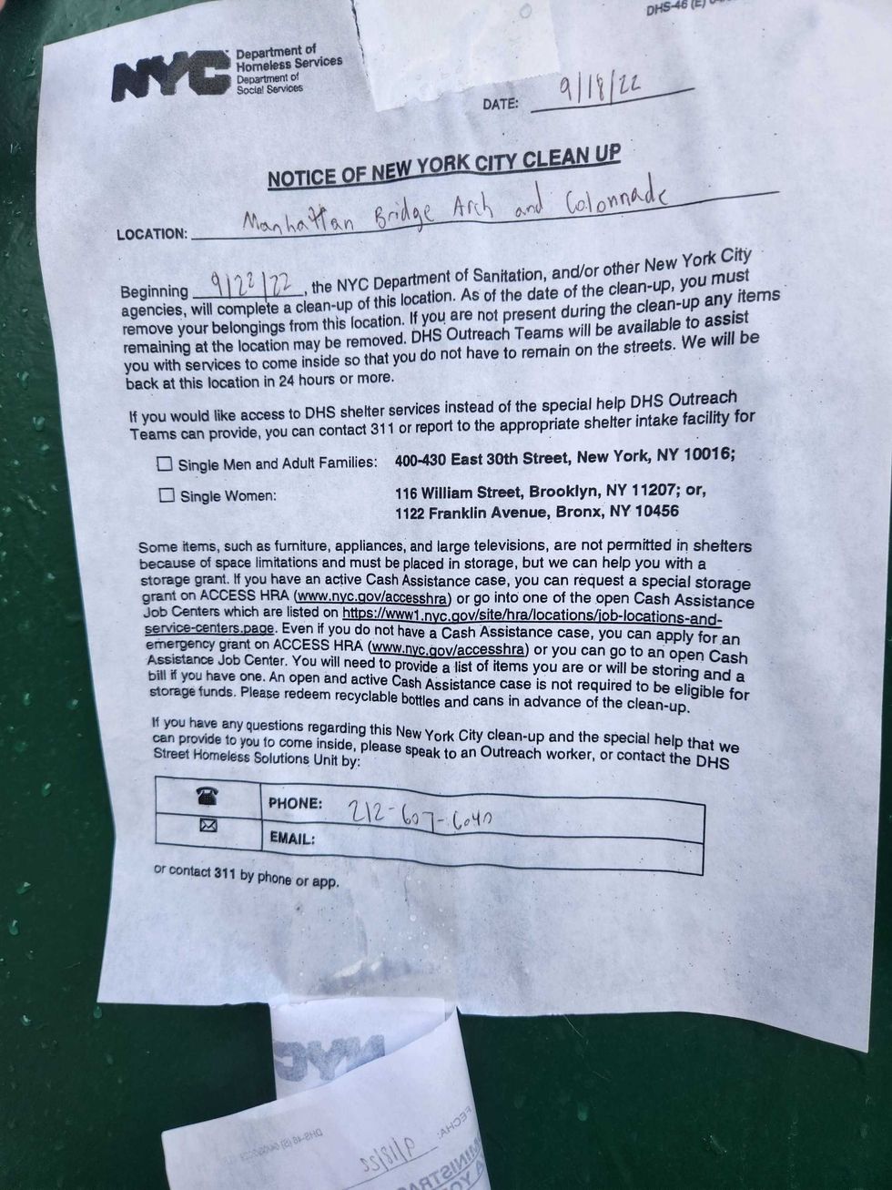 An English sweep notice posted on an electric box about 100 feet from the encampment.