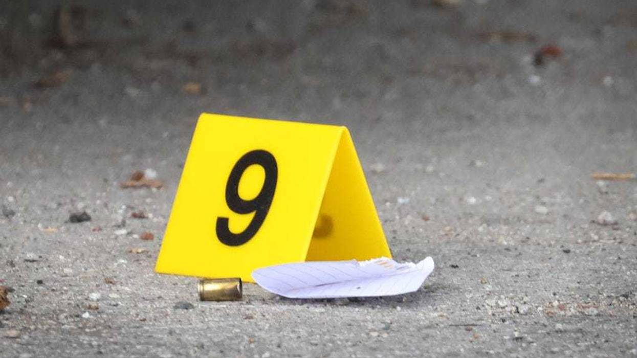 An evidence marker sits next to a shell casing at a crime scene where three people were shot at the Wentworth Gardens housing complex in the Bridgeport neighborhood on June 23, 2021 in Chicago, Illinois. A 24-year-old man died from injuries he suffered in the shooting and two others, a 22-year-old male and a 25-year-old male, were seriously wounded.