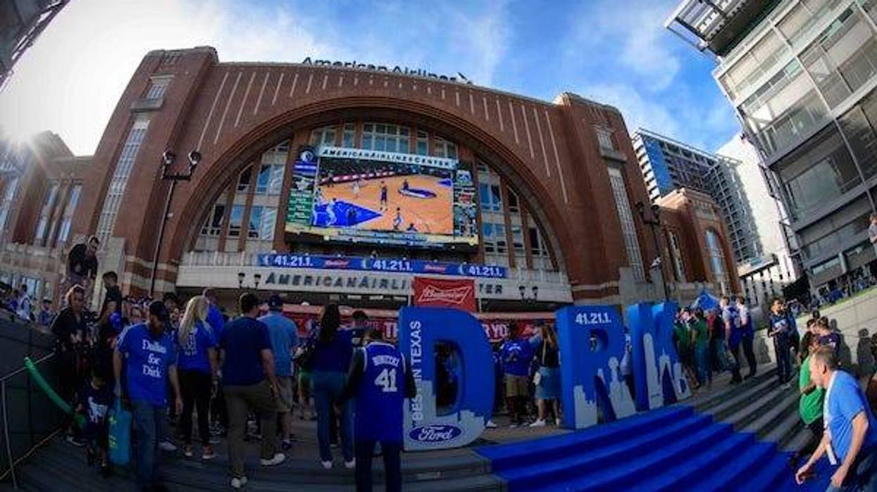 An exterior view of American Airlines Center and fans and posters of Dallas Mavericks forward Dirk Nowitzki before a game between the Mavericks and the Phoenix Suns at the American Airlines Center