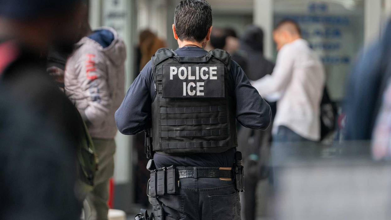 An ICE agent monitors hundreds of asylum seekers being processed upon entering the Jacob K. Javits Federal Building in New York City.